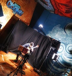 Spotlight on a musician rehearsing at Castaway 7's recording studio